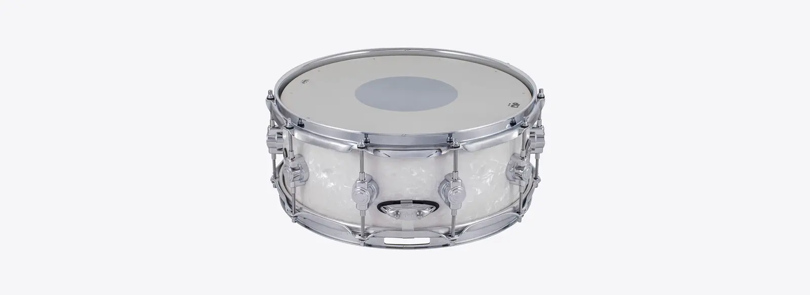 A photo of a white, metal snare drum.