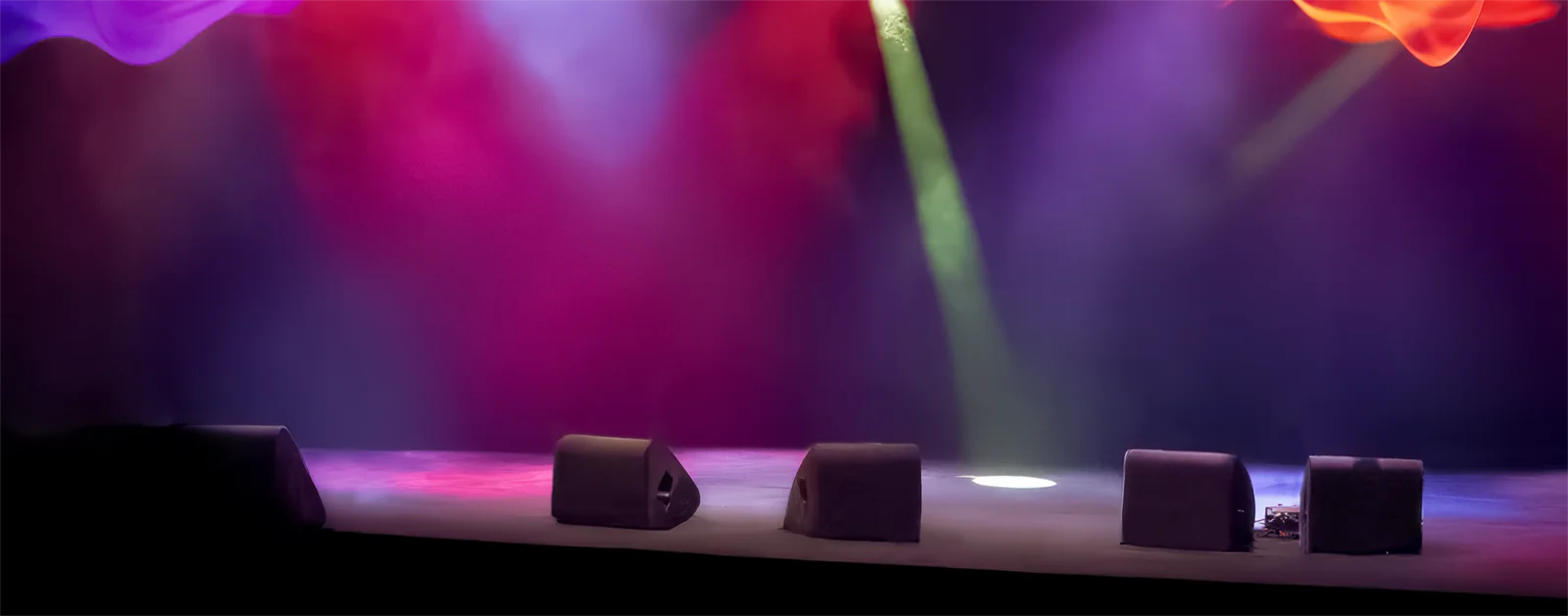 A close-up of an empty, colourfully-lit stage.